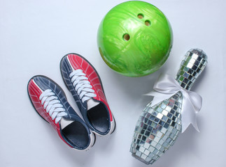 Bowling shoes, disco mirror skittle and bowling ball on white background. Indoor family sports. Top view. Flat lay. Minimalism