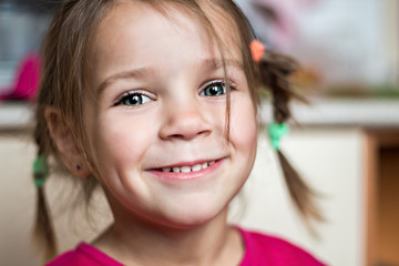 Beautiful expressive adorable happy cute laughing smiling baby infant toddler girl with ponytails showing teeth,