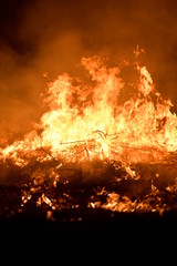 Fire on the field at night.