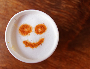 smiling face on cappuccino coffee takeaway, top view and space for text