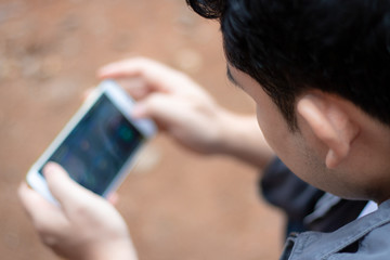 Overhead and close up view. Young men are playing games on smartphones.