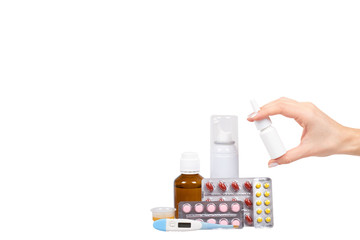 Bottle with medicine, nasal spray with hand. Antipyretic syrup and pills. Medication for cold...