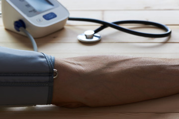 Close-up view of measure blood pressure of a man in clinic