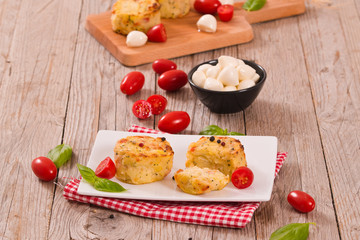 Potato gratins with mozzarella and tomatoes.