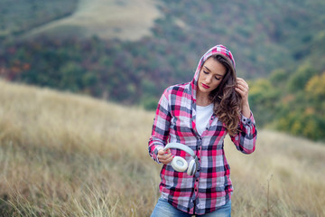 Young modern long hair girl with headphones at the middle of the field