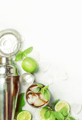 Alcoholic cocktail Cuba Libre, with rum, lime juice, cola and ice. Bar tools, top view, vertical toned image