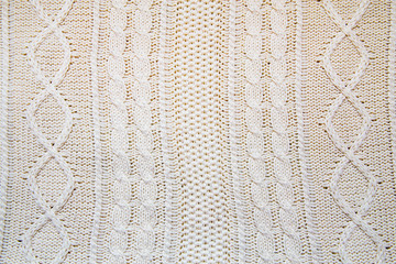 background of a large knitted fabric with braids, copy space
