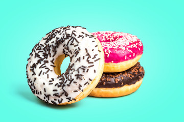 Sweet donuts isolated on green background