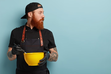 Concentrated male cooker focused away, whisks cream in yellow bowl, mixes ingredients, hears some...