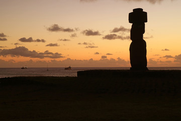 Silhouette of a Moai at Ahu Ko Te Riku against sunset sky and Pacific ocean, Easter Island, Chile