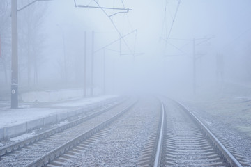 Two railway ruts directed into the fog