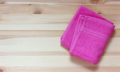 Obraz na płótnie Canvas pink Terry towel on the table, top view.
