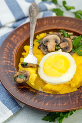 Delicious polenta with mushrooms and egg.