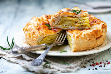 Puff pastry pie dish with potatoes and rosemary. - obrazy, fototapety, plakaty