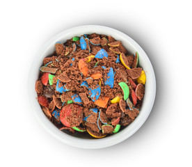 Top view of colorful chocolate buttons in bowl  on a white background
