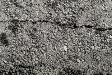 Old worn and cracked asphalt with crack. Cracked asphalt background