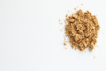 Fresh Ginger Powder Close up in Spoon on A Plain White Background