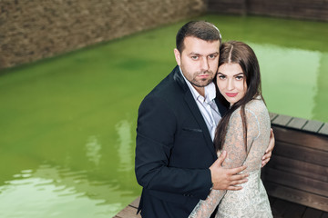 beautiful girl and guy hug together. woman in evening dress and a man in a suit together.