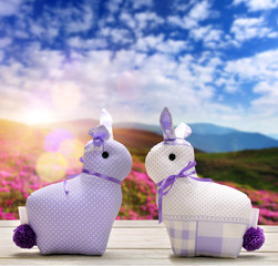 Two Easter bunnies and empty space for text. Easter holiday concept.