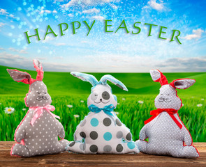 Three Easter bunnies Happy Easter text. Easter holiday concept.