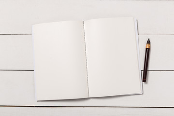 Blank book cover template with page in front side standing on white wood background flat lay.