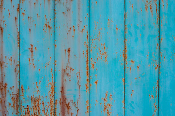 Old metal fence aquamarine color with traces of rust