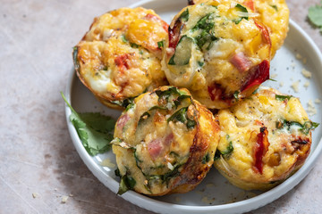 Delicious egg muffins with ham, cheese and vegetables