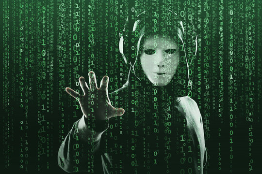 Anonymous computer hacker over abstract digital background. Obscured dark face in mask and hood. Data thief, internet attack, darknet fraud, dangerous viruses and cyber security.