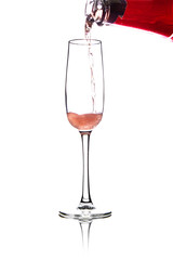 pouring pink wine into glass, isolated on white background