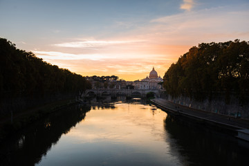 Naklejka premium View on the Vatican in Rome, in the Tiber river, Italy, at sunset with dramatic sky. Scenic travel background