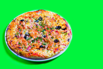 hot tasty fresh pizza on a plate close-up. green background