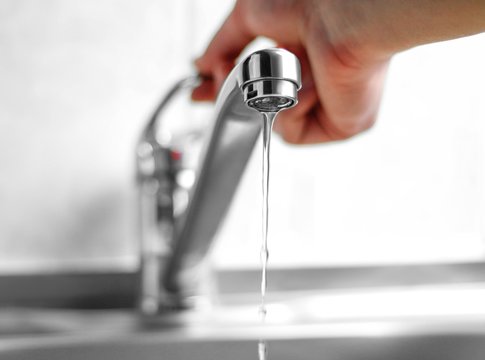 Hand Opens The Water Tap. Close Up