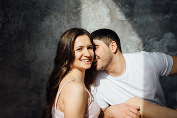 cheerful couple in love having a good time on the floor in the apartment