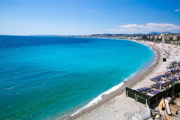 Fototapeta na wymiar Nice, beautiful beach, French Riviera, Cote d'Azur or Coast of Azure. Bright turquoise water. 
