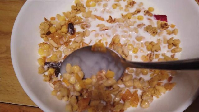 Stir granola and milk with poon
