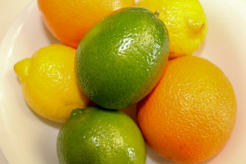 Lemons, limes and oranges. Close up of fresh whole citrus fruits