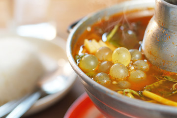 Thai tradition food: Kaeng Som is Thai sour soup with egg fish and vegetables. Served with tamarind soup in hot pot. Famous food of Thailand. Shoot in studio, Clean food good taste concept.