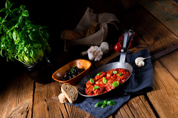 Baked mini meatballs in tomato sauce with basil