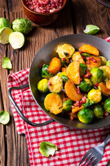 Brussels sprouts potato pan with bacon in rustic style