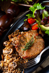 Pork steak with mushrooms and buckwheat groats and mango salad