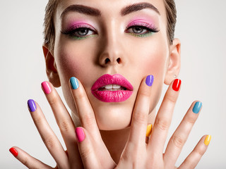 Beautiful fashion woman with a colored nails. Attractive white girl with multicolor manicure.