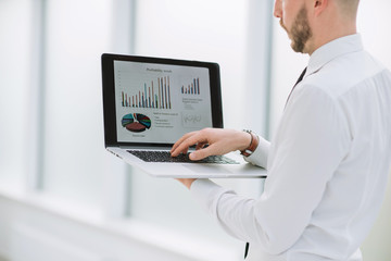 close up. businessman analyzing financial data on laptop