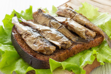 Tasty fish sandwich with bread and canned sprats
