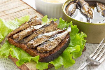 Tasty fish sandwich with bread and canned sprats
