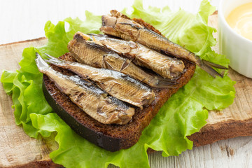 Tasty fish sandwich with bread and canned sprats