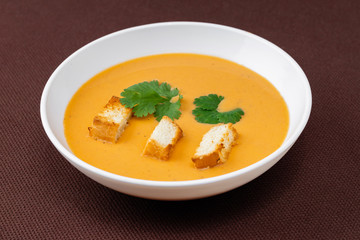 cream soup with crackers and herbs
