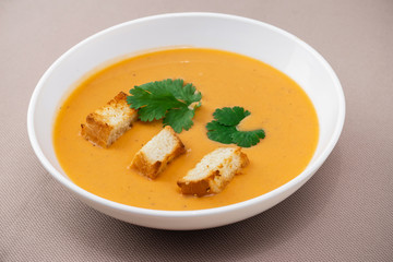 cream soup with crackers and herbs