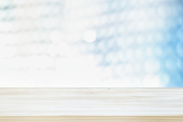 Photo of old wooden table in front of white and silver glitter lights background. Ready for product display montage