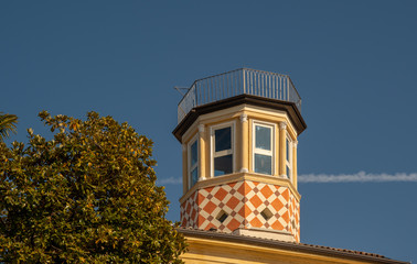 Close-up of a little tower on a roof with geometric orange decoration, Lazise, Veneto, Italy