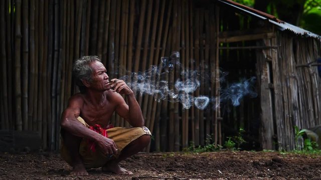 Old men are smoking. in rural Thailand. (Slow motion)